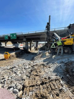 Crews continue to blast behind the bridge piers on the west side of the interstate bridges over U.S. 2/7.