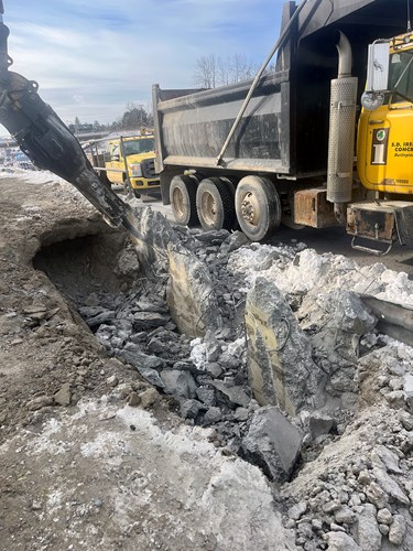 Crews work to remove the retaining wall on U.S. 2/7 just south of Lower Mountain View Drive in Colchester, VT.
