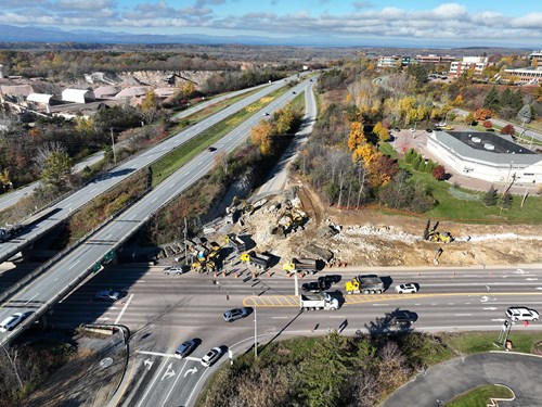 Crews remove material from previous blasting events along U.S. 2/7 near the I-89 Exit 16 northbound on-ramp.