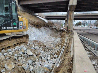 Crews continue to remove earth material to facilitate the installation of the retaining wall along the west side of U.S. 2/7.