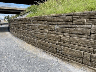 Work progresses on the retaining walls on either side of U.S. 2/7. These retaining walls will allow for the construction of the proposed pedestrian and bicycle connection through the interchange.