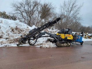 Drill used to bore into the ground to determine the location of ledge beneath the roadway surface.