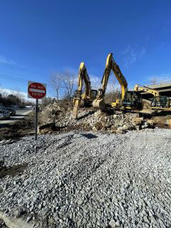 Crews removing material including ledge to facilitate the installation of the retaining wall along the west side of U.S. 2/7.