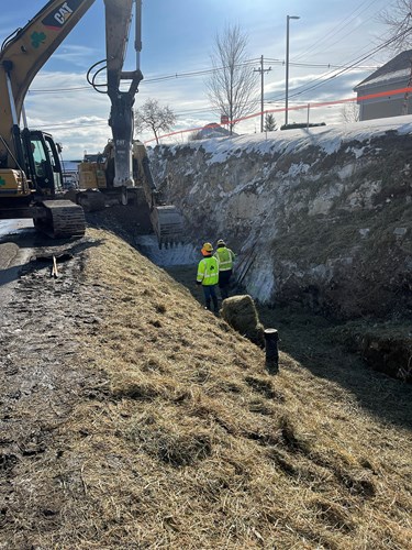 Crews install a stormwater grass channel on the south side of Upper Mountain View Drive near its intersection with U.S. 2/7 in Colchester, VT.