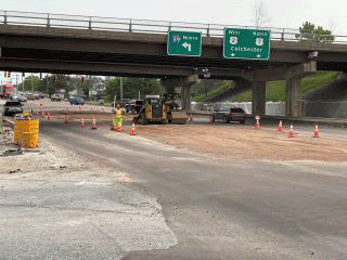 Crews backfilling and grading area in preparation for temporary pavement.