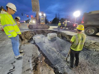 Crews installing stormwater infrastructure as part of the Exit 16 DDI Project.