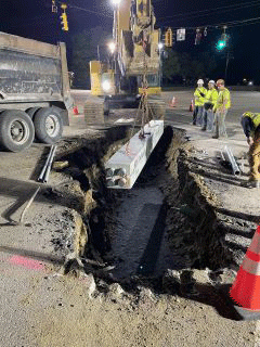 Crews working to install underground utility - duct bank.