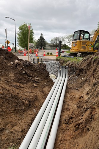 Crews install conduit sleeves for traffic signals.