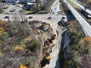 Aerial view of construction progress in October 2025. Blasting activities and ledge removal along U.S. 2/7 and the I-89 northbound on-ramp. 