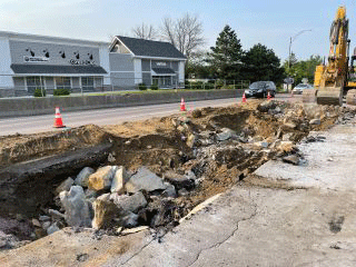 Blasting activities to break up tough subsurface ledge beneath the roadway surface. 