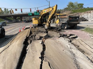 Blasting activities to break up tough subsurface ledge beneath the roadway surface. 